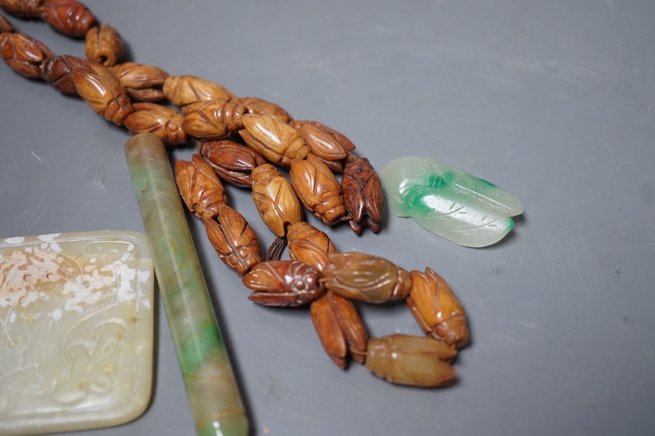 Chinese carved Hardstone ‘cicada’ bead necklace, a carved hardstone plaque a jadeite pipe mouthpiece and similar cicada